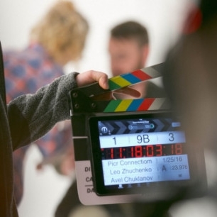 An image of a filmshoot focused on a clapperboard